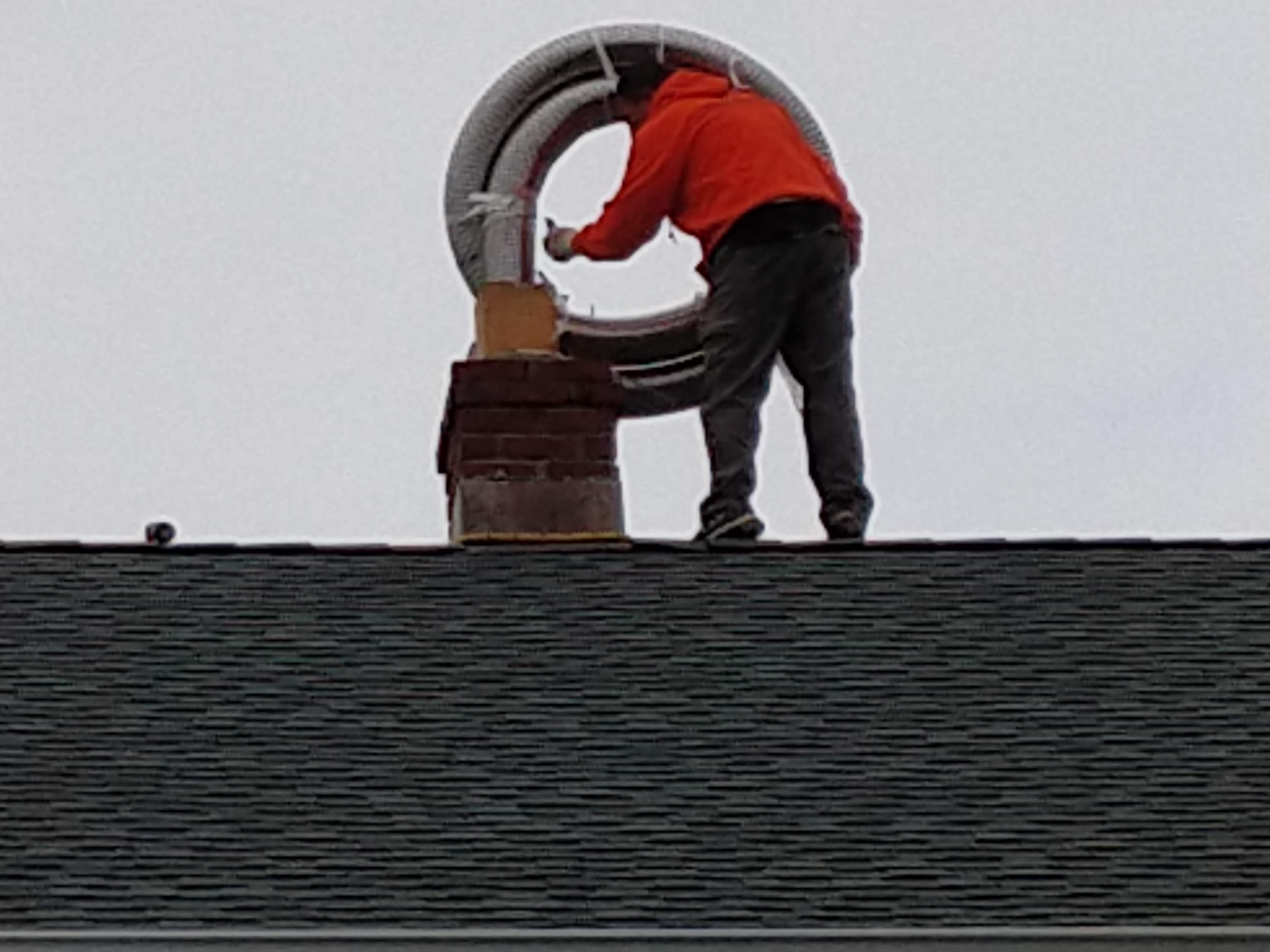 Flexible stainless chimney liner being installed in Glen Cove, New York